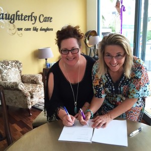 Daughterly Care founders Kate and Verlie signing Kincare partner agreement