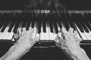 Aged hands playing the piano