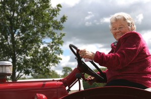 senior farming woman on tractor